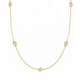 14kt Gold necklace with bezel set diamonds on a white background