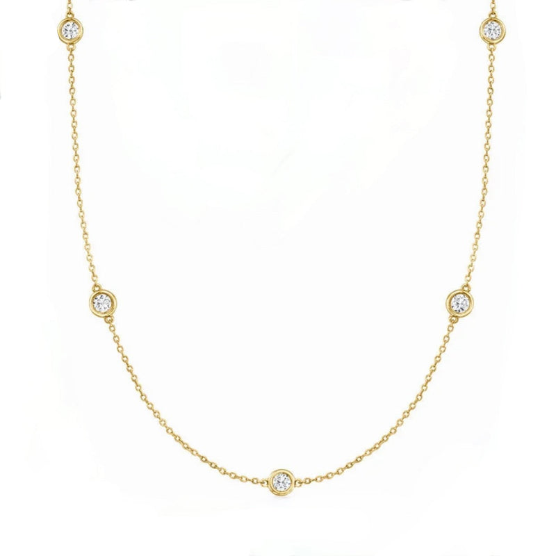 14kt Gold necklace with bezel set diamonds on a white background