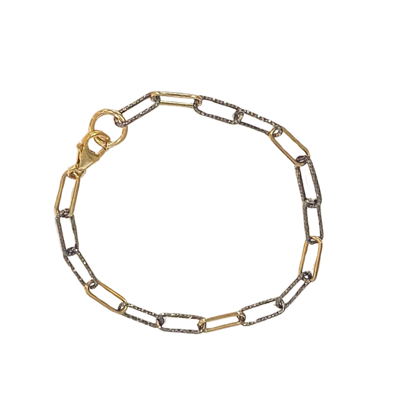 Two-tone gold and silver chain bracelet on a white background