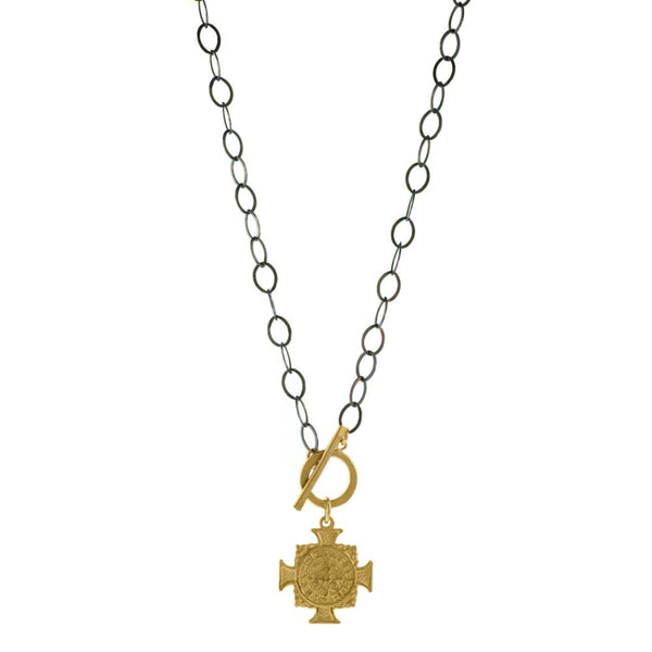 Our ARIANA - EDGE cross pendant necklace, combines classic with a little edge. A large, matte gold, cross pendant is suspended from a 14kt gold-filled toggle on an oxidized, sterling silver chain. Add a little bit of edge day or night. Made to last and made in the USA. Chain measures 18" . 